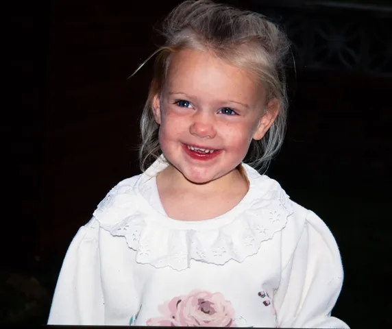 Restored slide of a young girl in a white top smiling